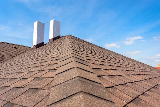 A shingle roofline with chimney flashing